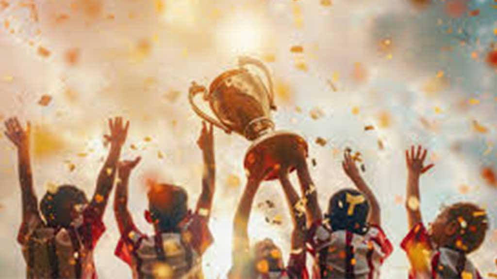 A children's sports team celebrates a championship with a trophy and falling confetti